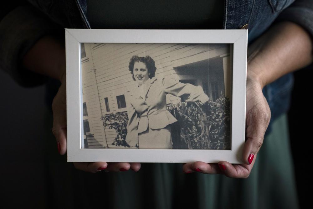 Stacy Cordova holds a framed photo of her aunt Mary Franco, who was sterilized when she was 13 in 1934