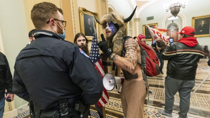 Trump supporters inside the Capitol being confronted by U.S. Capitol Police officers outside the Senate Chamber