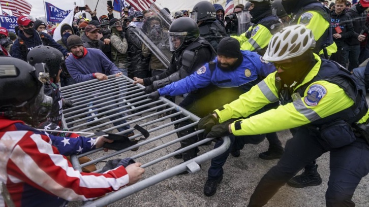 Pro-Trump protesters attempting to break through a police barrier at the Capitol in Washington