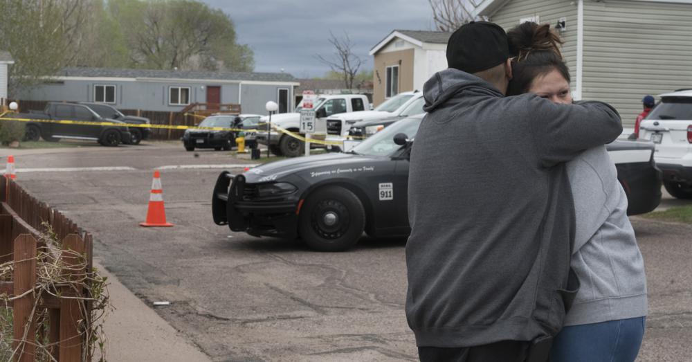 Family and friends of the victims comfort each near the scene of the shooting