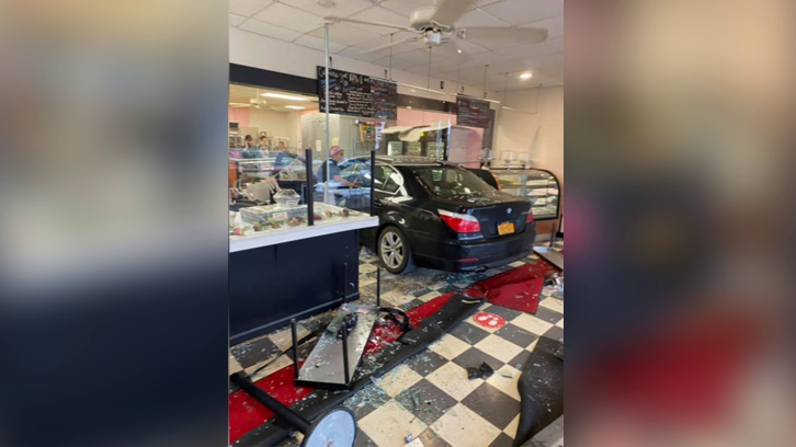 the 82-year-old woman's BMW inside the Dolce and Biscotti bakery in Clifton Park, New York, after it crashed through the front windows