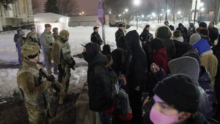 A group of protesters confront several National Guard members outside a museum in Kenosha, Wis., late Tuesday, following the announcement that no charges would be filed against the police officer who shot Jacob Blake in August