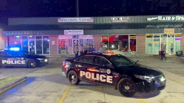 Police cars outside an Oklahoma City strip mall Wednesday night where a suspect hit the wrong building during an attempted ram-raid