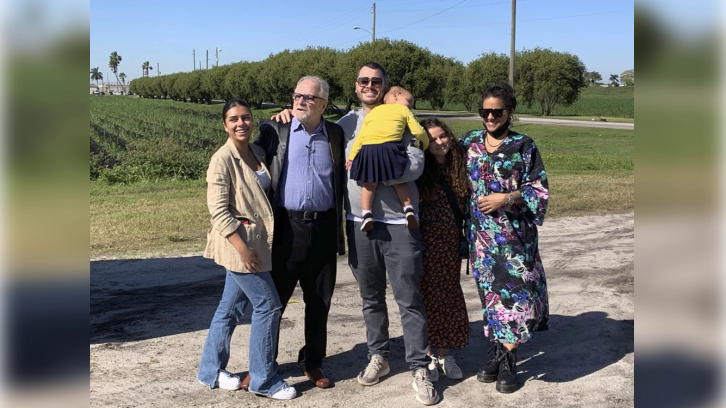 Richard DeLisi is surrounded by his granddaughter Sade, left, son Rick, his daughter-in-law Vida, two granddaughters Aya and Vida, after his release from prison