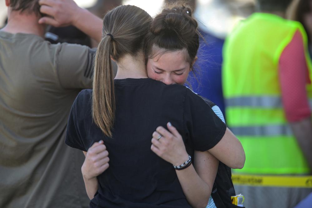 Students comfort each other after a shooting at Rigby Middle School in Rigby, Idaho