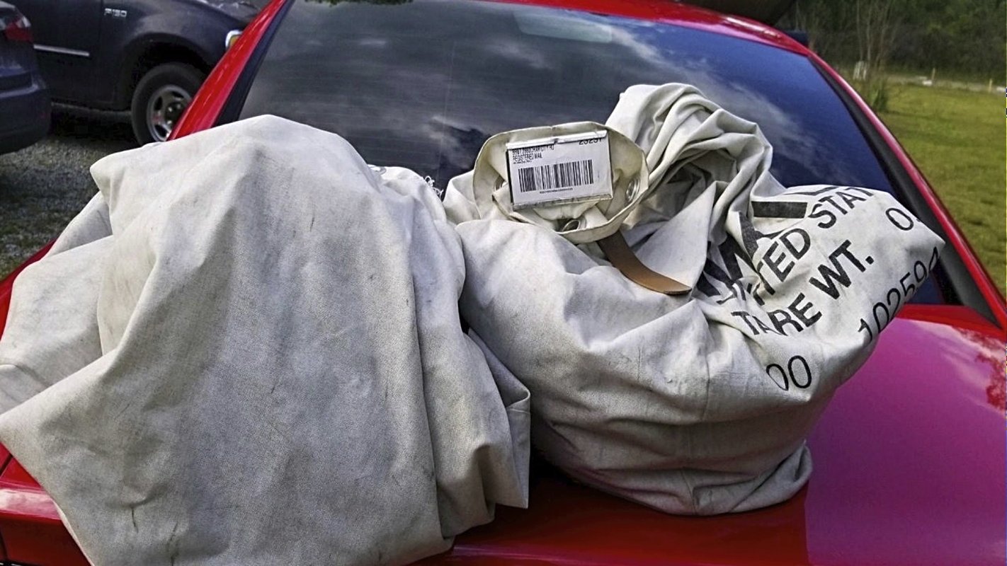 cash-stuffed sacks on car hood