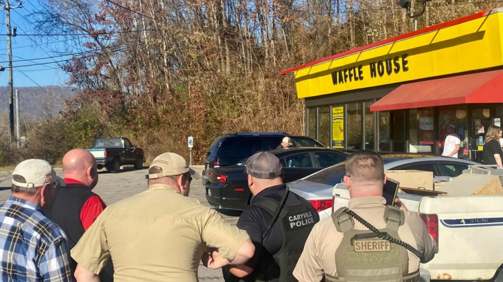 Law enforcement standing outside the Waffle House in Caryville