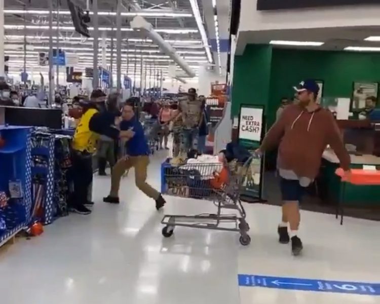 colleague trying to restrain worker as shopper walks away with trolley