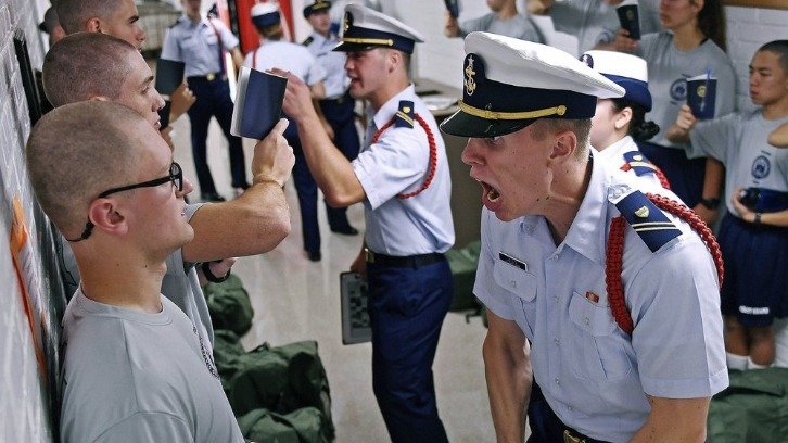 Whisky 2 company Cadre Jacob Denns, right, shouts instructions to swab Nicolas Fisher, left, of Pelham, N.H., on the first day of last summer's seven-week indoctrination to military academy life for the Class of 2023 at the U.S. Coast Guard Academy in New London, Conn.