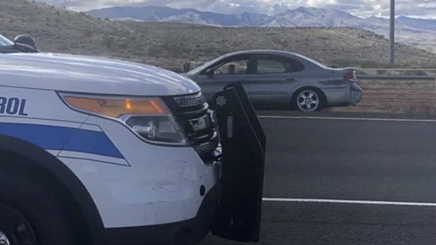 The Arizona highway patrol vehicle (foreground) which rammed the woman's Ford Taurus (background), finally causing her to stop