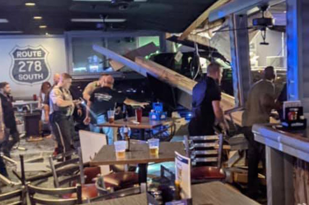 Cops assess the damage after a disgruntled patron plowed his truck through the front of a Georgia bar