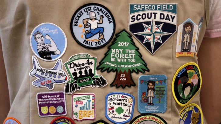 patches covering the back of a Girl Scout's vest