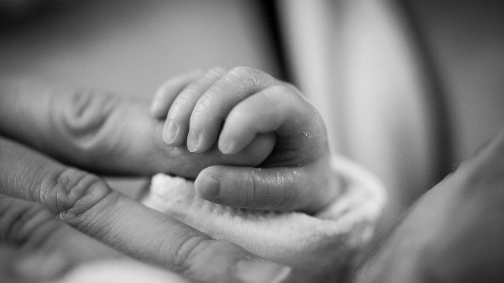 Baby holding finger