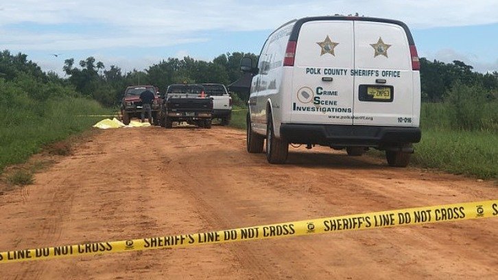 Investigators at the crime scene by Lake Streety in Frostproof, Florida