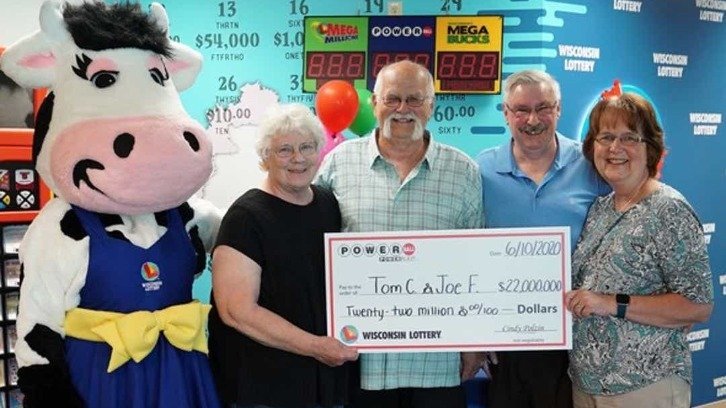 Tom Cook, Joseph Feeney and their wives receiving their Wisconsin Lottery check