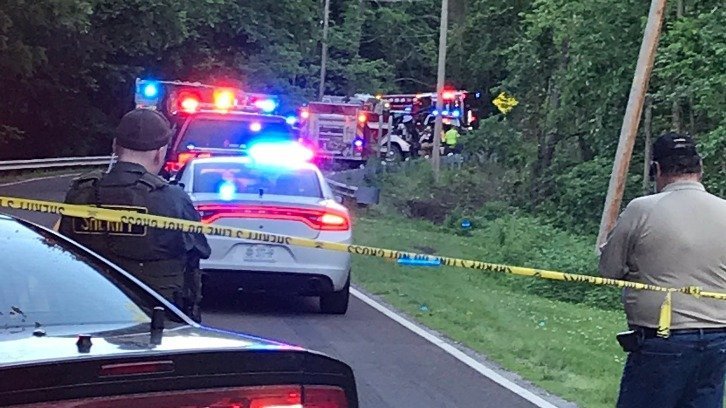 Emergency vehicles lining the road at the site of the young brothers' fatal crash in Jackson County, Missouri