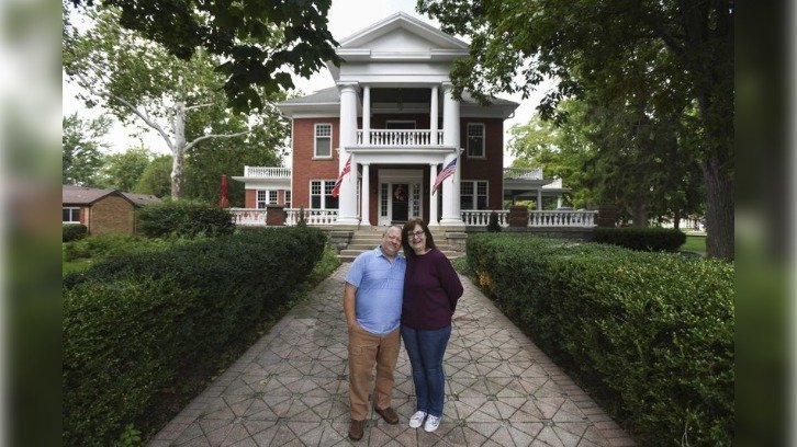 Kjersten and Greg Offenecker outside the Nordic Pineapple, their Civil War-era mansion turned bed and breakfast in St. Johns, Michigan