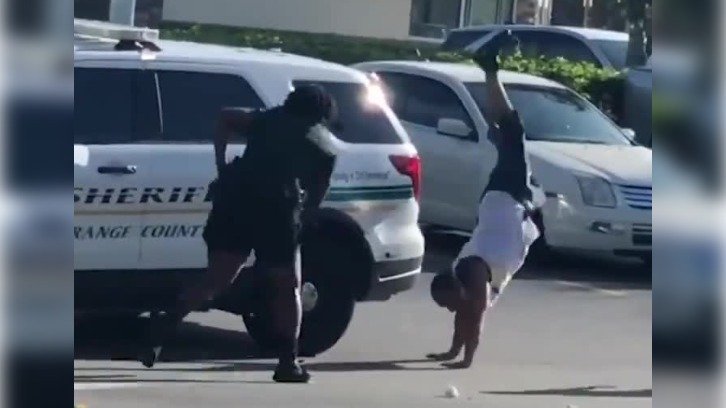 still of video showing Florida man cartwheeling away from cops