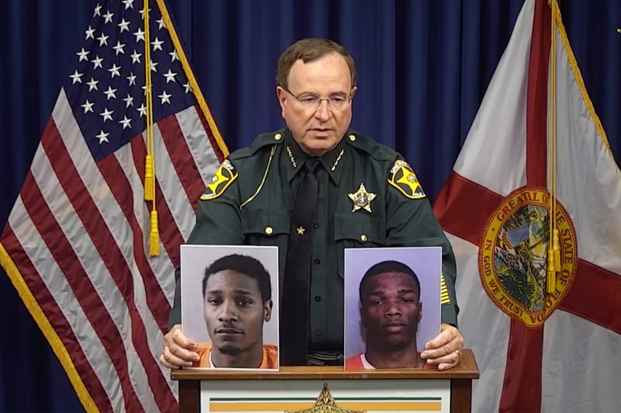 Polk County Sheriff Grady Judd shows mug shots of Chad Berrien, left, and Kevonte' Wilson at a press conference.